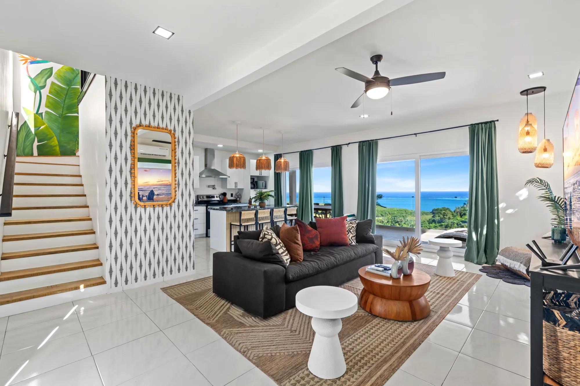 Bright open-plan living room with an ocean view at Coral Views, Roatán